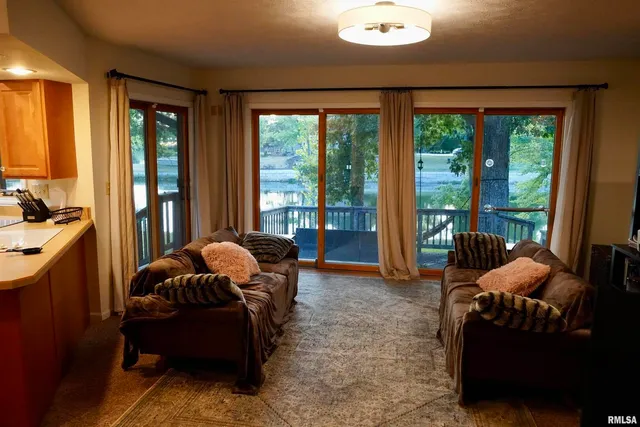 a bedroom with a bed and a flat tv screen on dresser