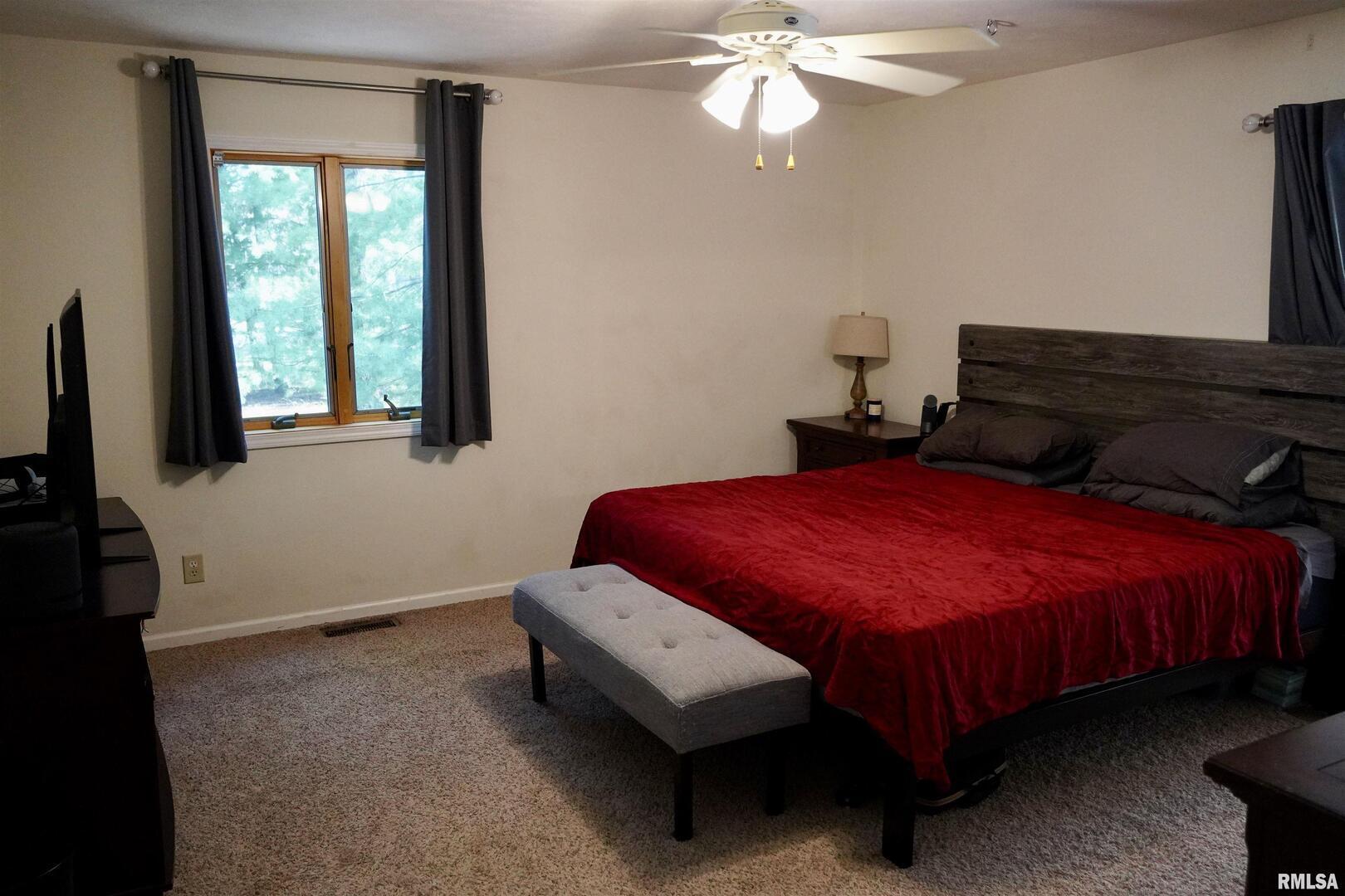 15316 Lake Point Drive Benton, IL 62812 - Photo 35 of 58 a bedroom with a bed and a flat tv screen on dresser