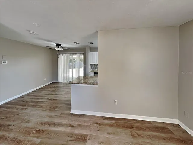 a view of wooden floor and windows in a room