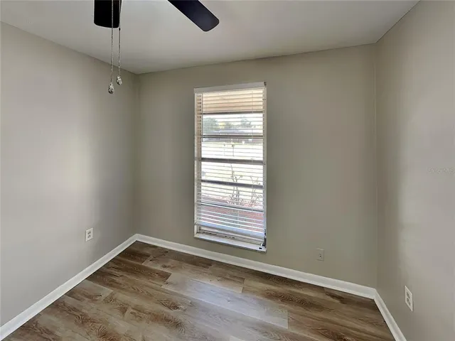 a view of empty room with ceiling fan