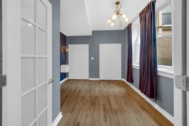a view of hallway with wooden floor and staircase