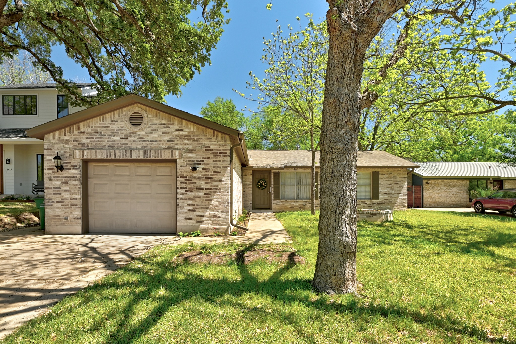 4619 Banister Lane Austin, TX 78745 - Photo 1 of 34 View of front of property with a garage, concrete driveway, brick siding, and a front yard
