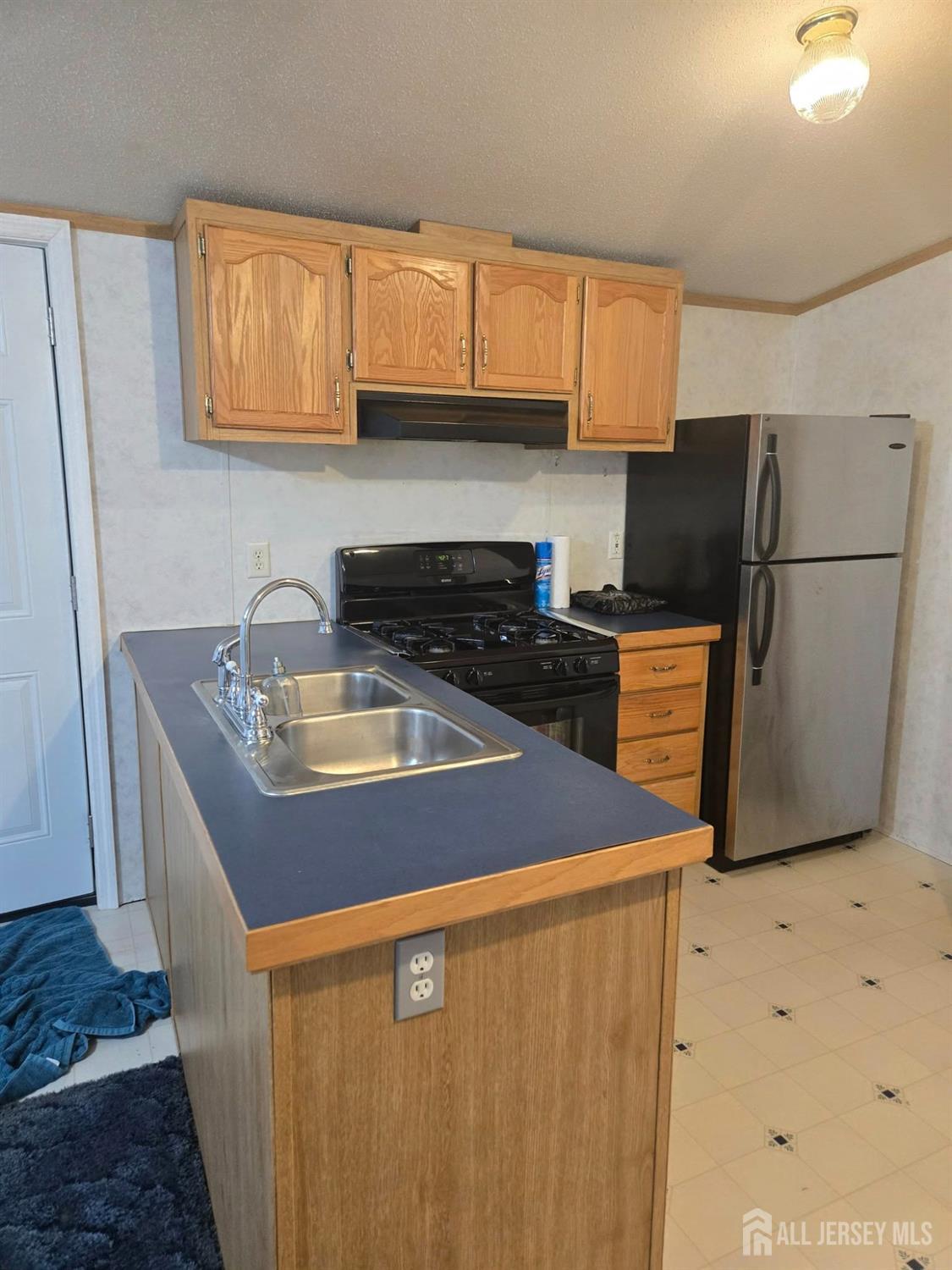 8 3rd Street Avenel, NJ 07001 - Photo 6 of 10 a kitchen with stainless steel appliances granite countertop a sink a stove a refrigerator a microwave and cabinets