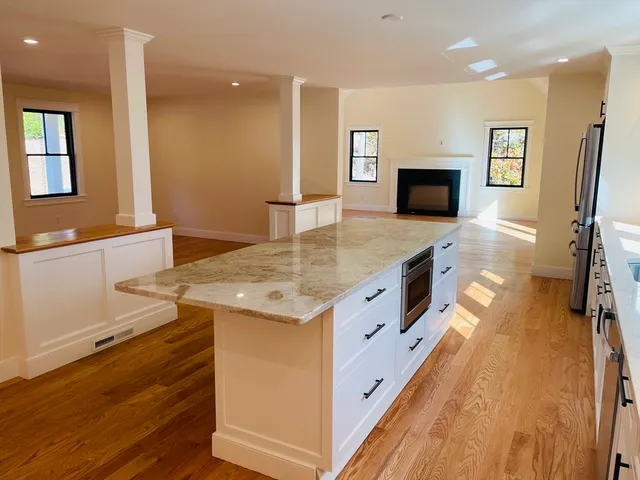a spacious bathroom with a granite countertop sink a mirror and shower