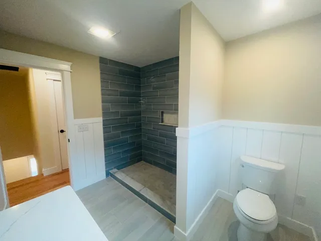 a bathroom with a toilet and a shower