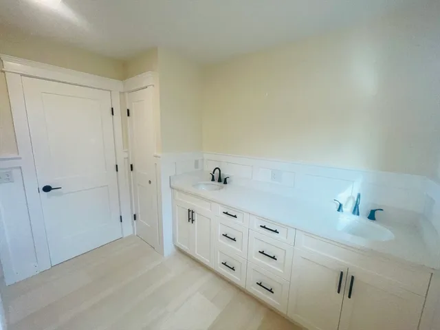 a spacious bathroom with double vanity sink and a mirror