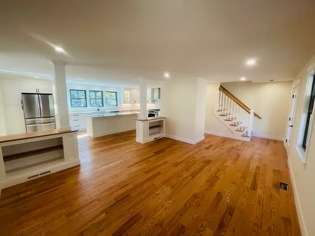 a spacious bedroom with a bed and a large window