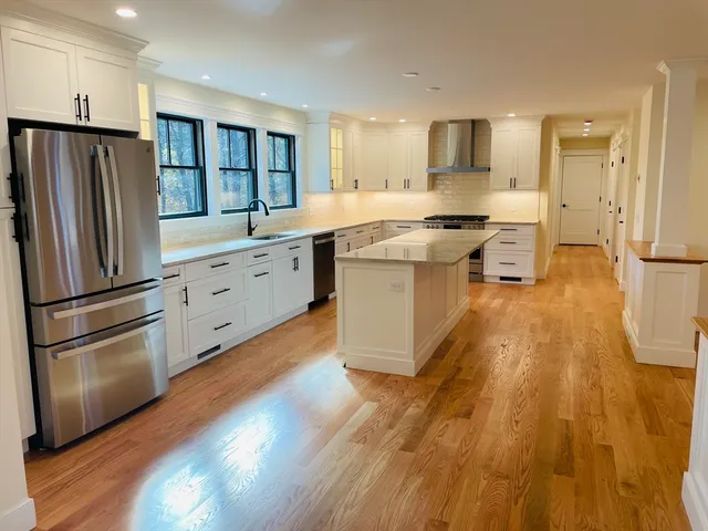 a kitchen with stainless steel appliances a refrigerator sink and cabinets
