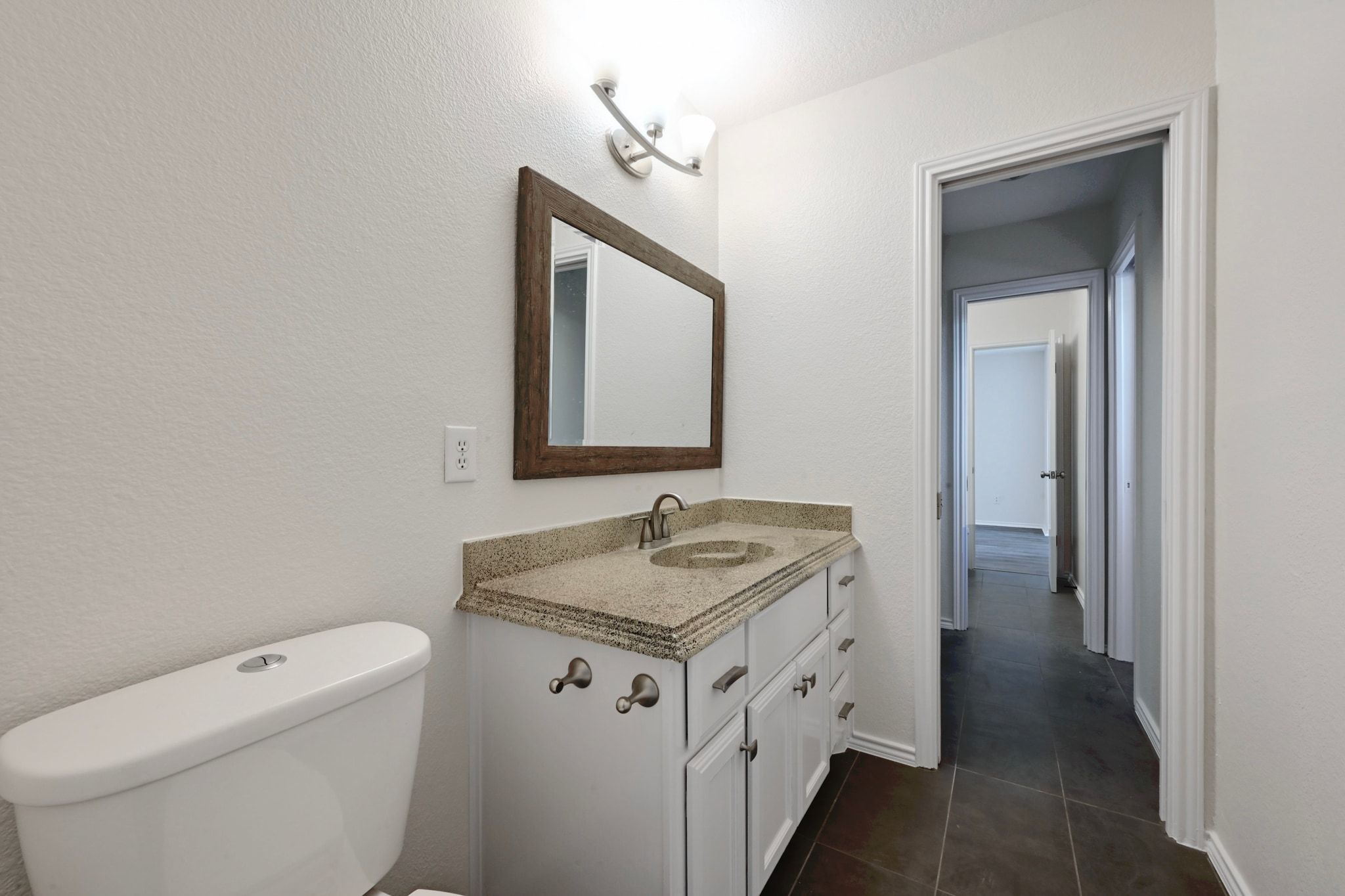 201 Comanche Camp Kyle, TX 78640 - Photo 19 of 37 a bathroom with a granite countertop sink and a mirror