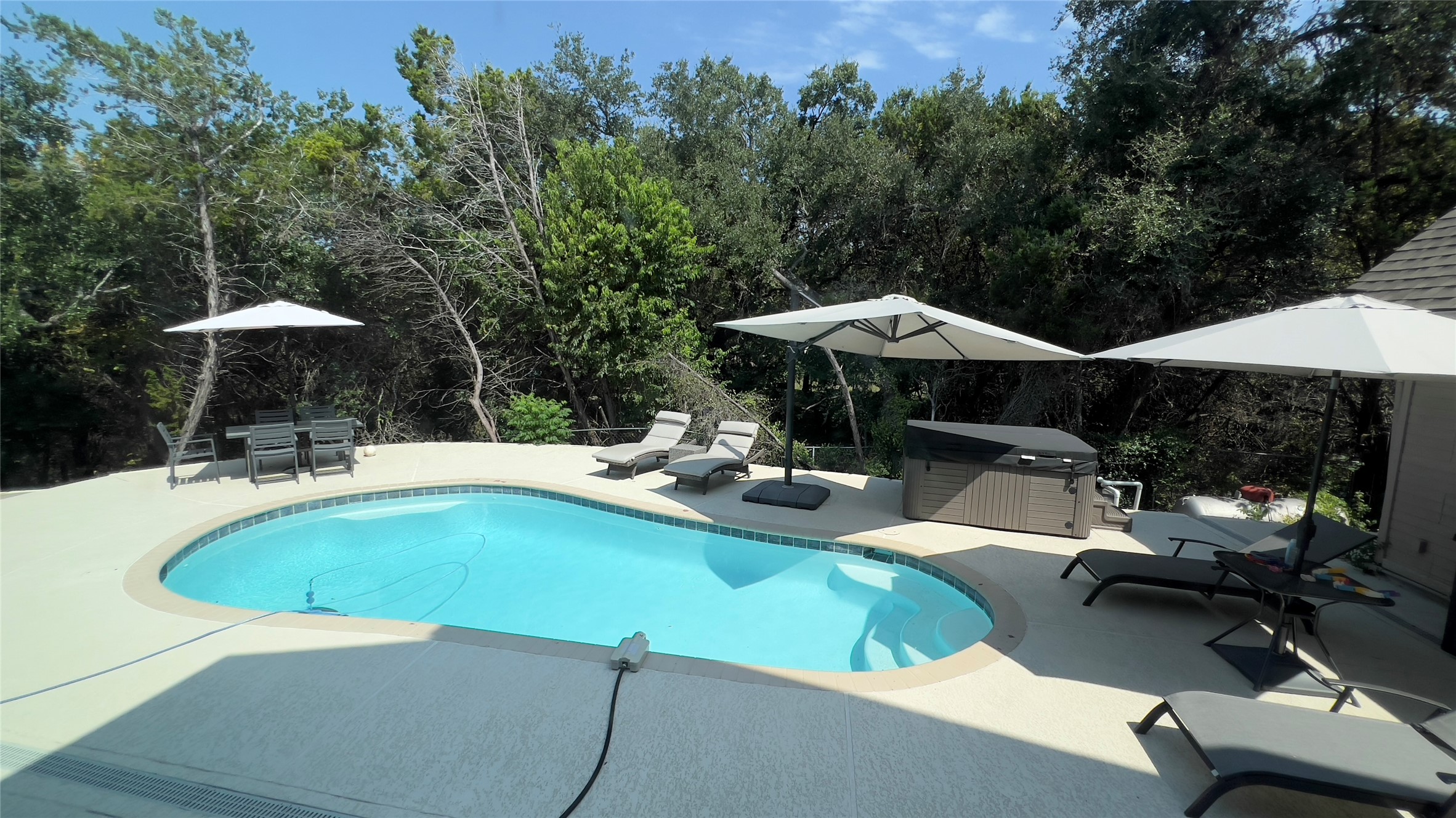 201 Comanche Camp Kyle, TX 78640 - Photo 2 of 37 a view of swimming pool with outdoor seating and trees