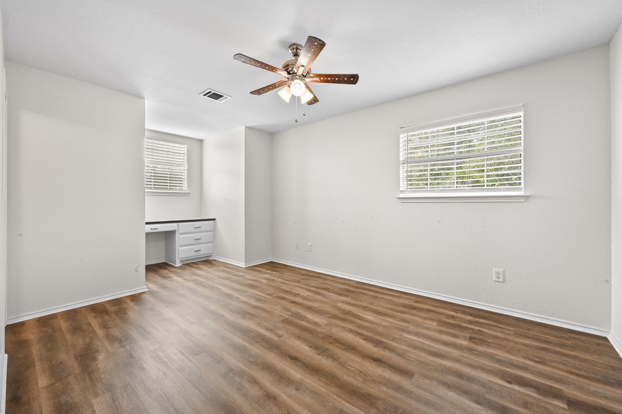 201 Comanche Camp Kyle, TX 78640 - Photo 21 of 37 a view of an empty room with a window and wooden floor