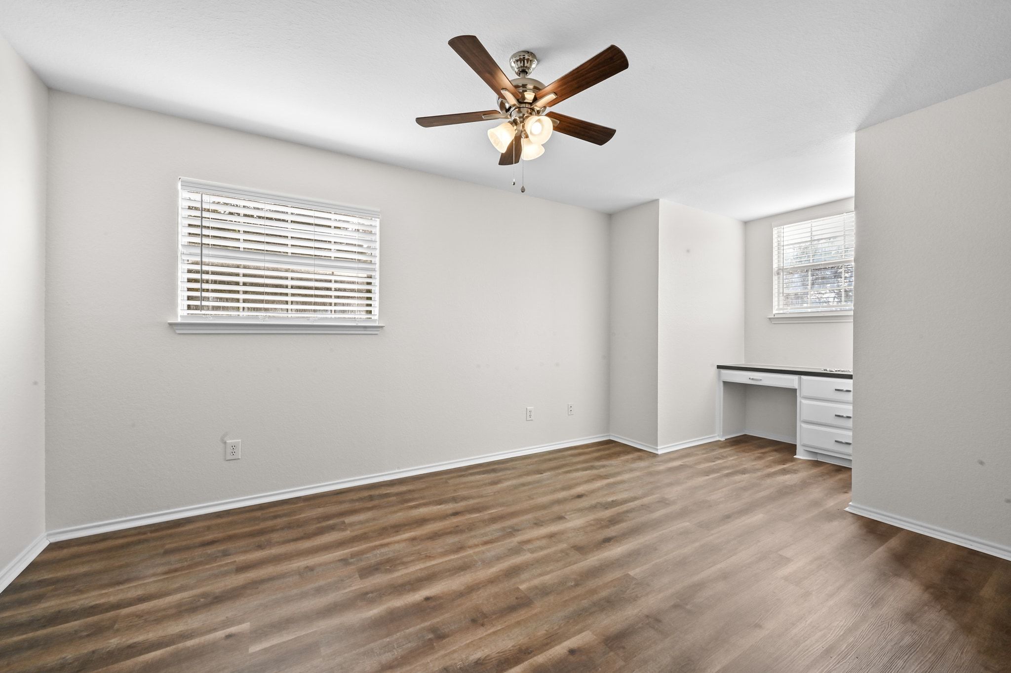 201 Comanche Camp Kyle, TX 78640 - Photo 22 of 37 a view of an empty room with a window and a ceiling fan