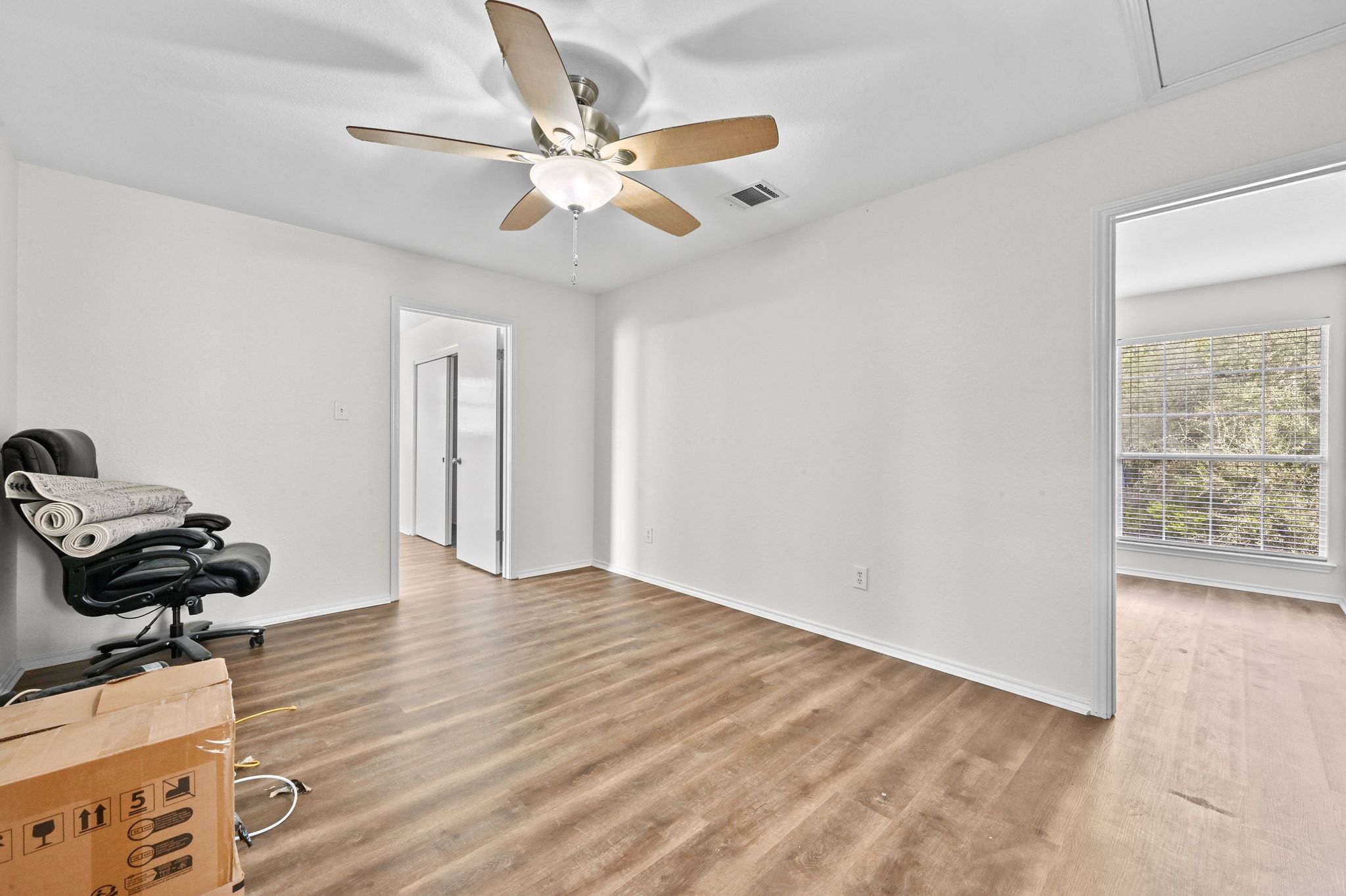 201 Comanche Camp Kyle, TX 78640 - Photo 23 of 37 a view of a workspace with wooden floor and white walls