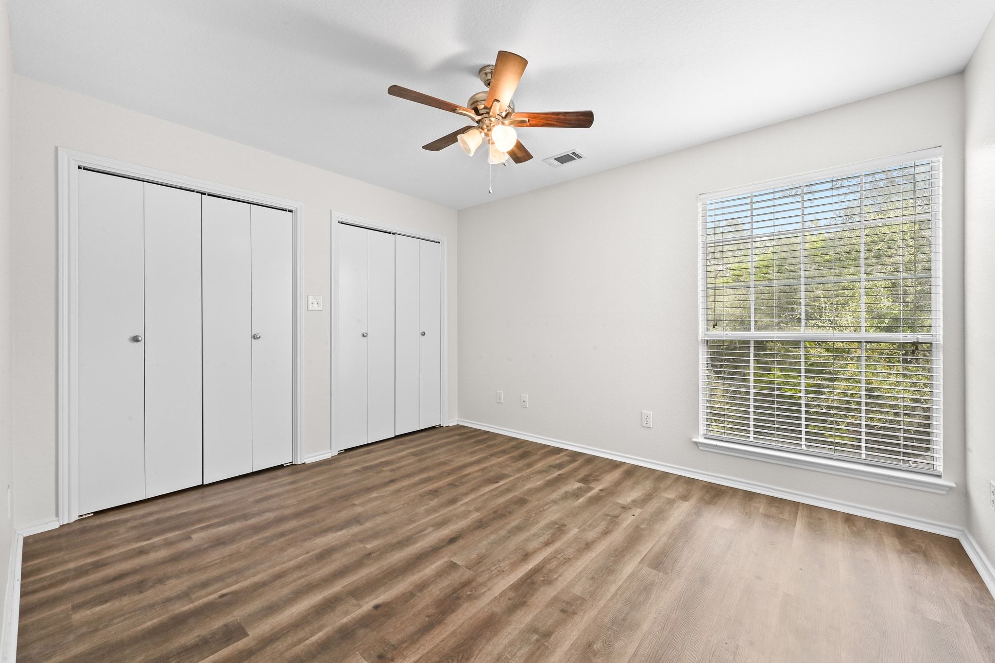 201 Comanche Camp Kyle, TX 78640 - Photo 24 of 37 a view of an empty room with wooden floor and a window