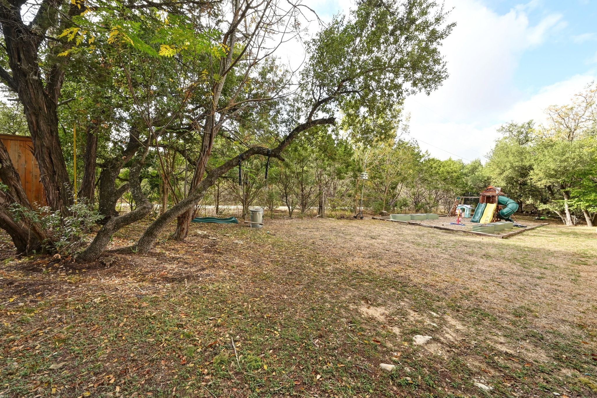 201 Comanche Camp Kyle, TX 78640 - Photo 30 of 37 a view of outdoor space with deck and trees