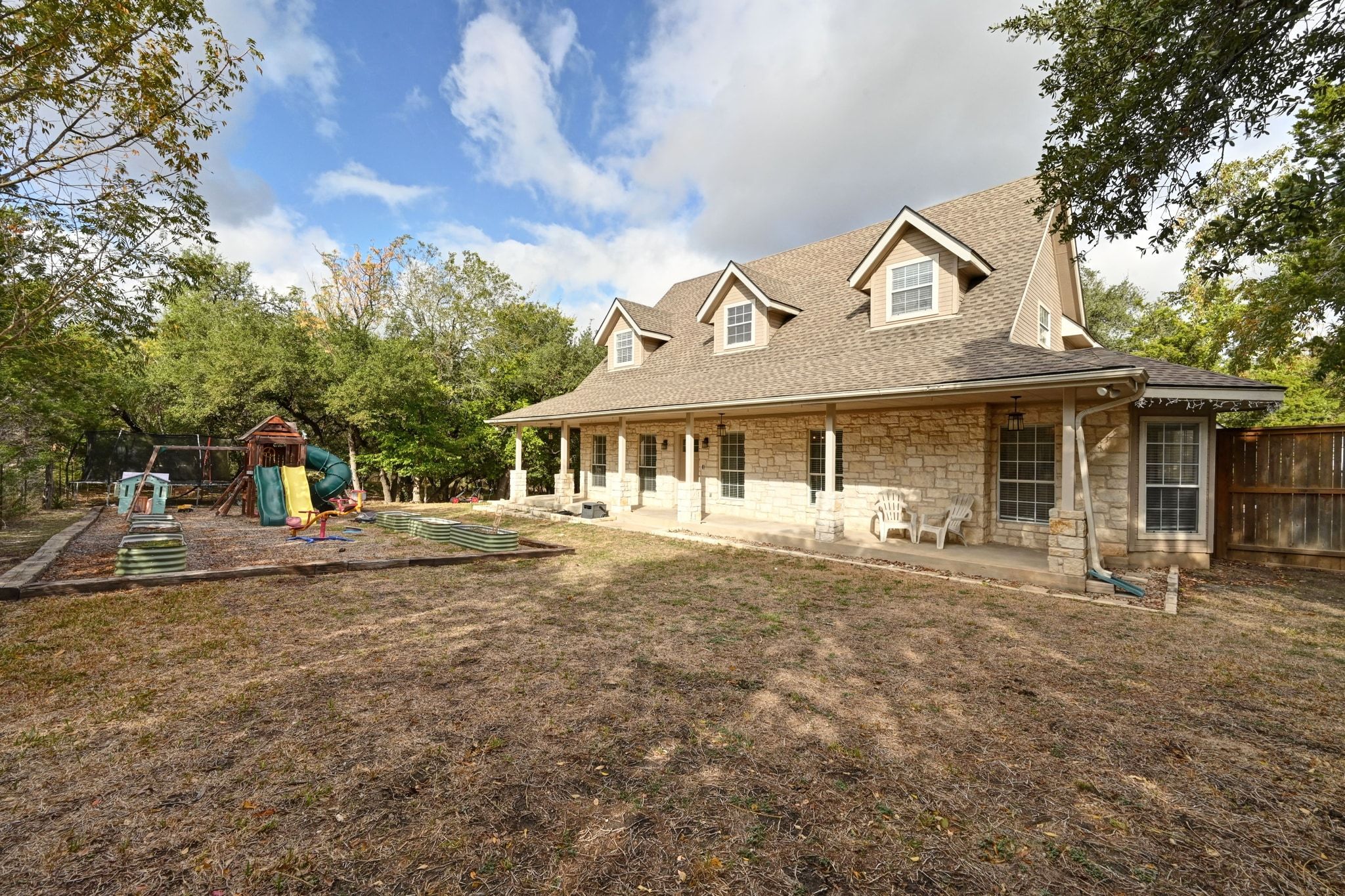 201 Comanche Camp Kyle, TX 78640 - Photo 33 of 37 a front view of a house with a garden