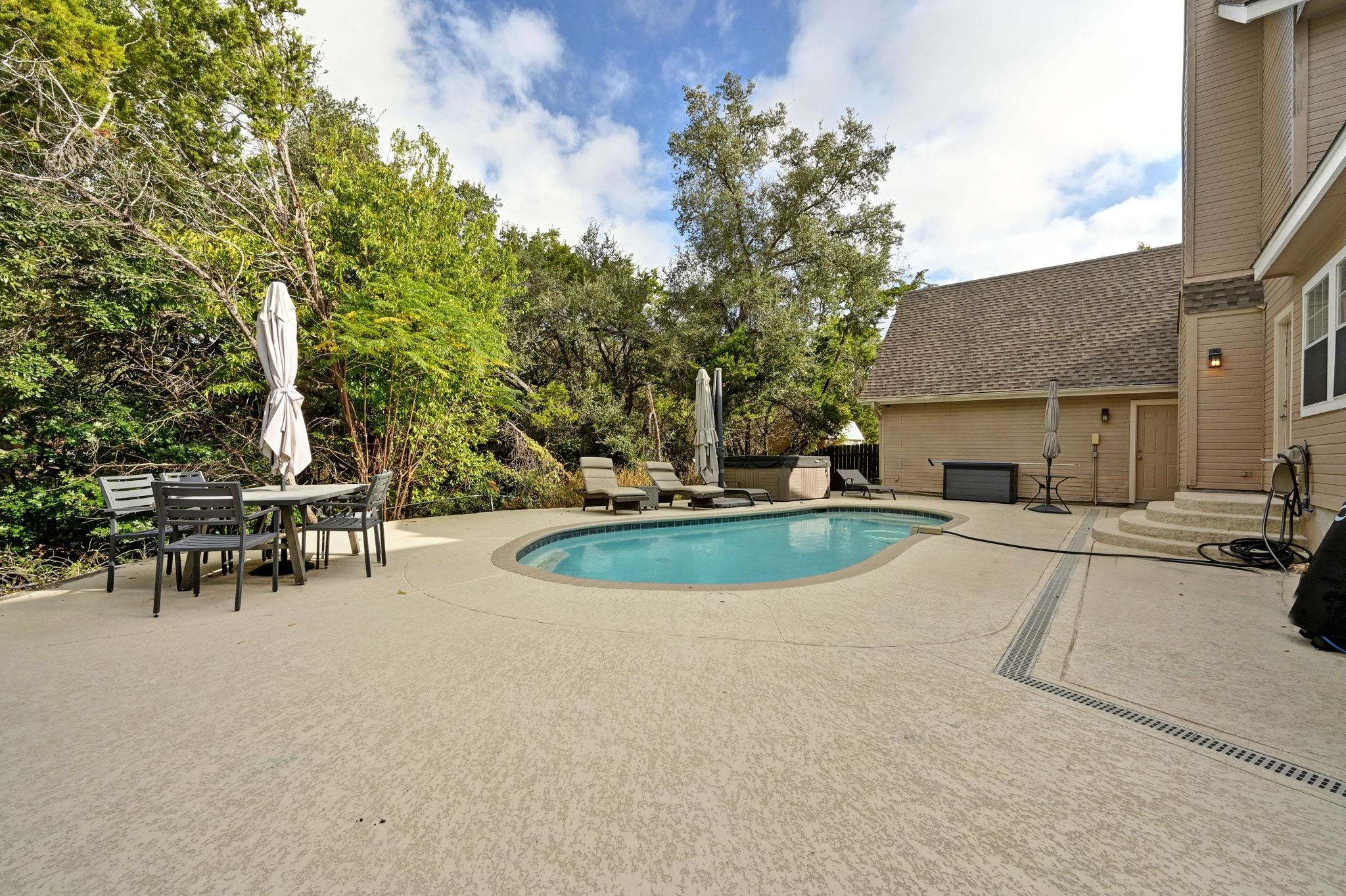 201 Comanche Camp Kyle, TX 78640 - Photo 36 of 37 a view of a swimming pool with a bench and trees