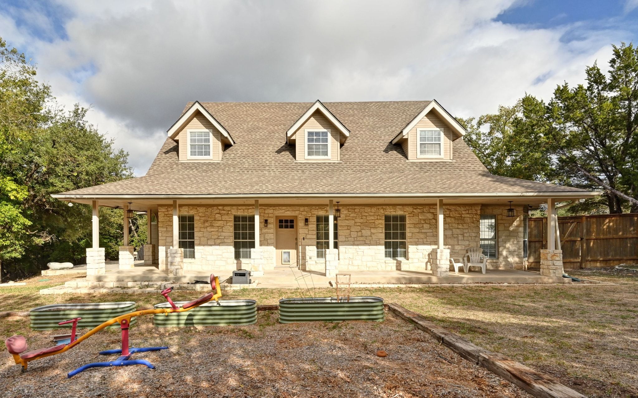 201 Comanche Camp Kyle, TX 78640 - Photo 4 of 37 a front view of a house with garden