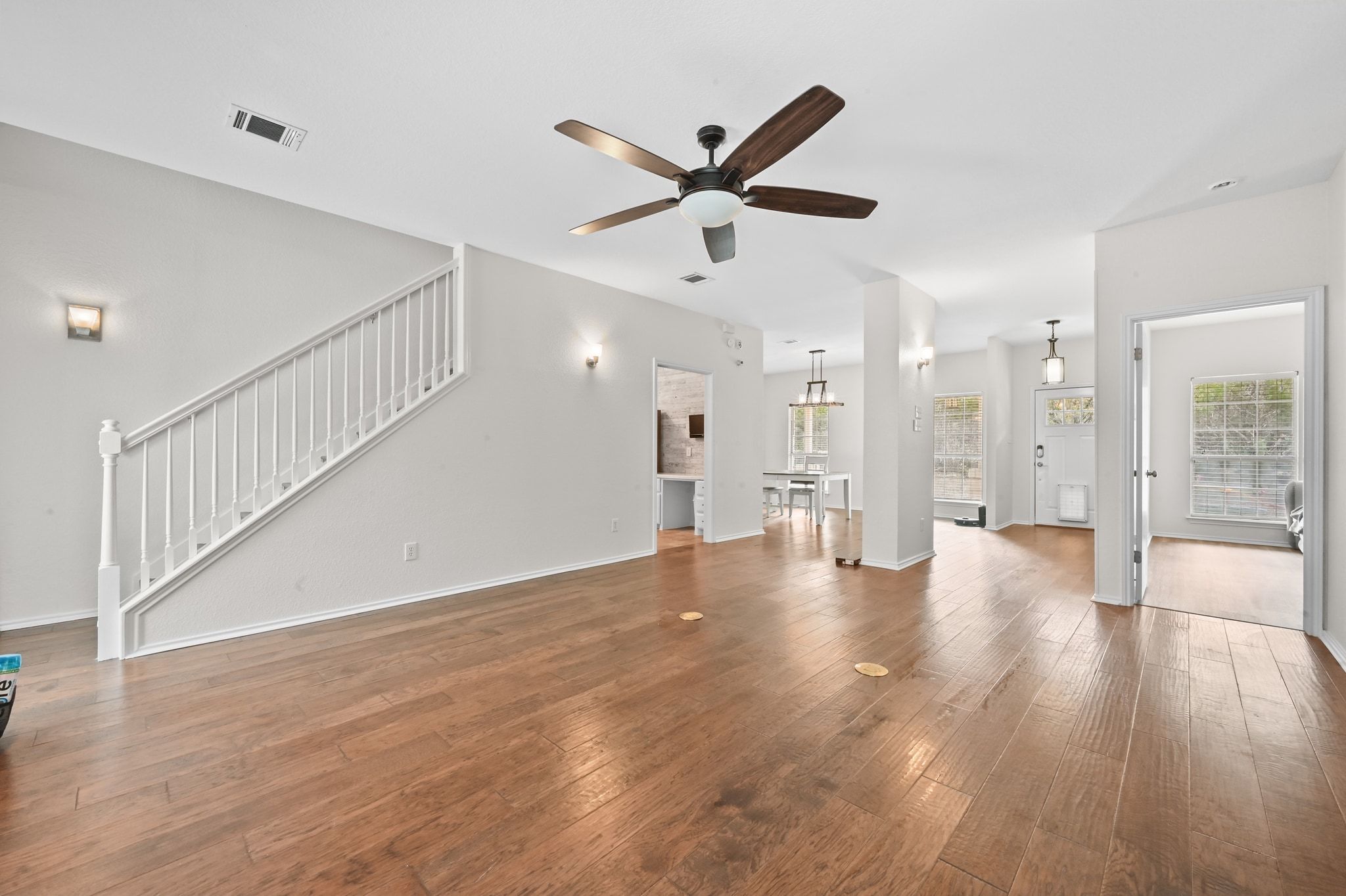 201 Comanche Camp Kyle, TX 78640 - Photo 5 of 37 a view of an empty room with wooden floor and a ceiling fan