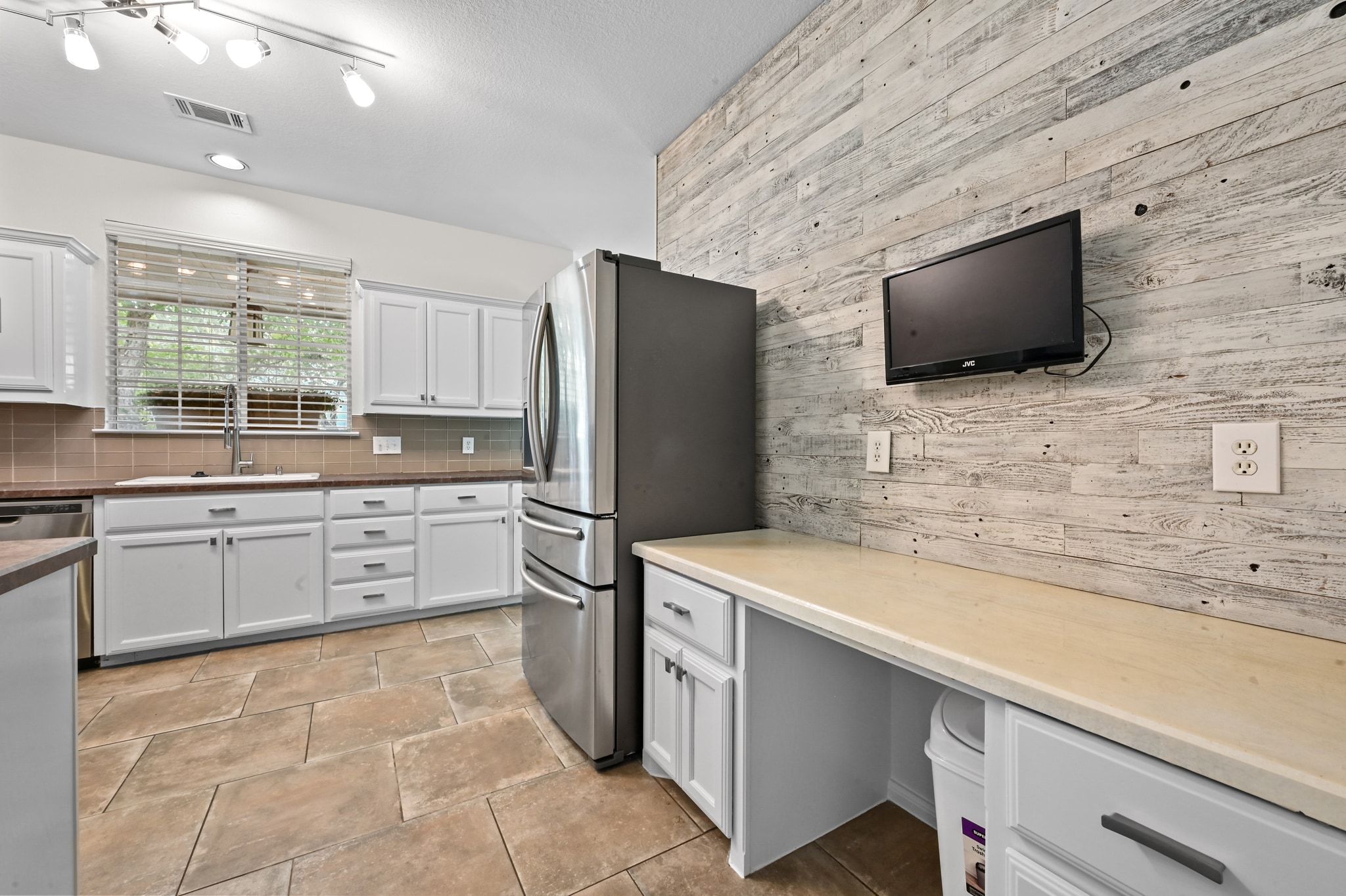 201 Comanche Camp Kyle, TX 78640 - Photo 10 of 37 a kitchen with stainless steel appliances a refrigerator sink and microwave