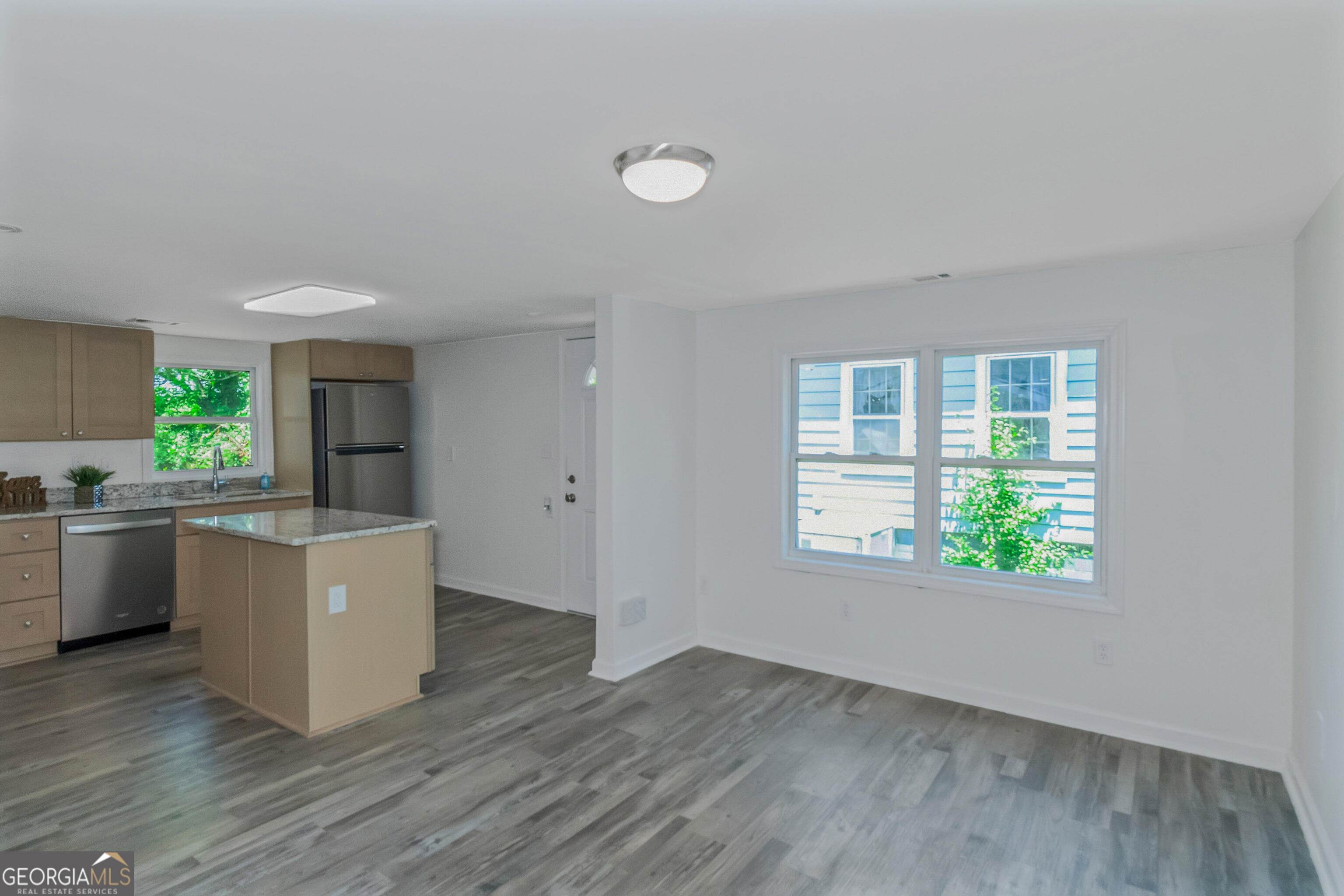 204 Mill Street Barnesville, GA 30204 - Photo 12 of 35 a room with a window wooden floor and kitchen view
