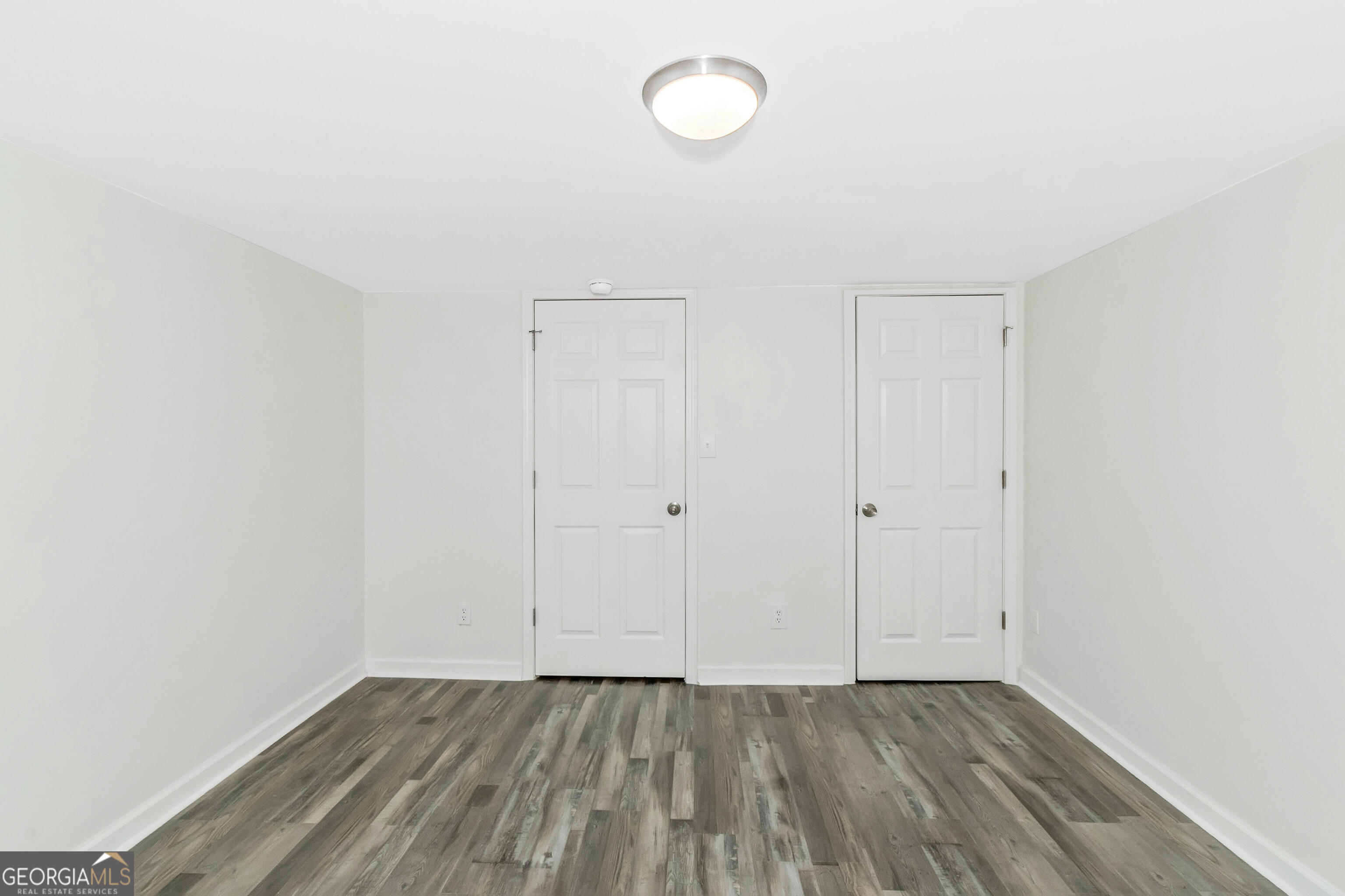 204 Mill Street Barnesville, GA 30204 - Photo 18 of 35 a view of an empty room with wooden floor and closet