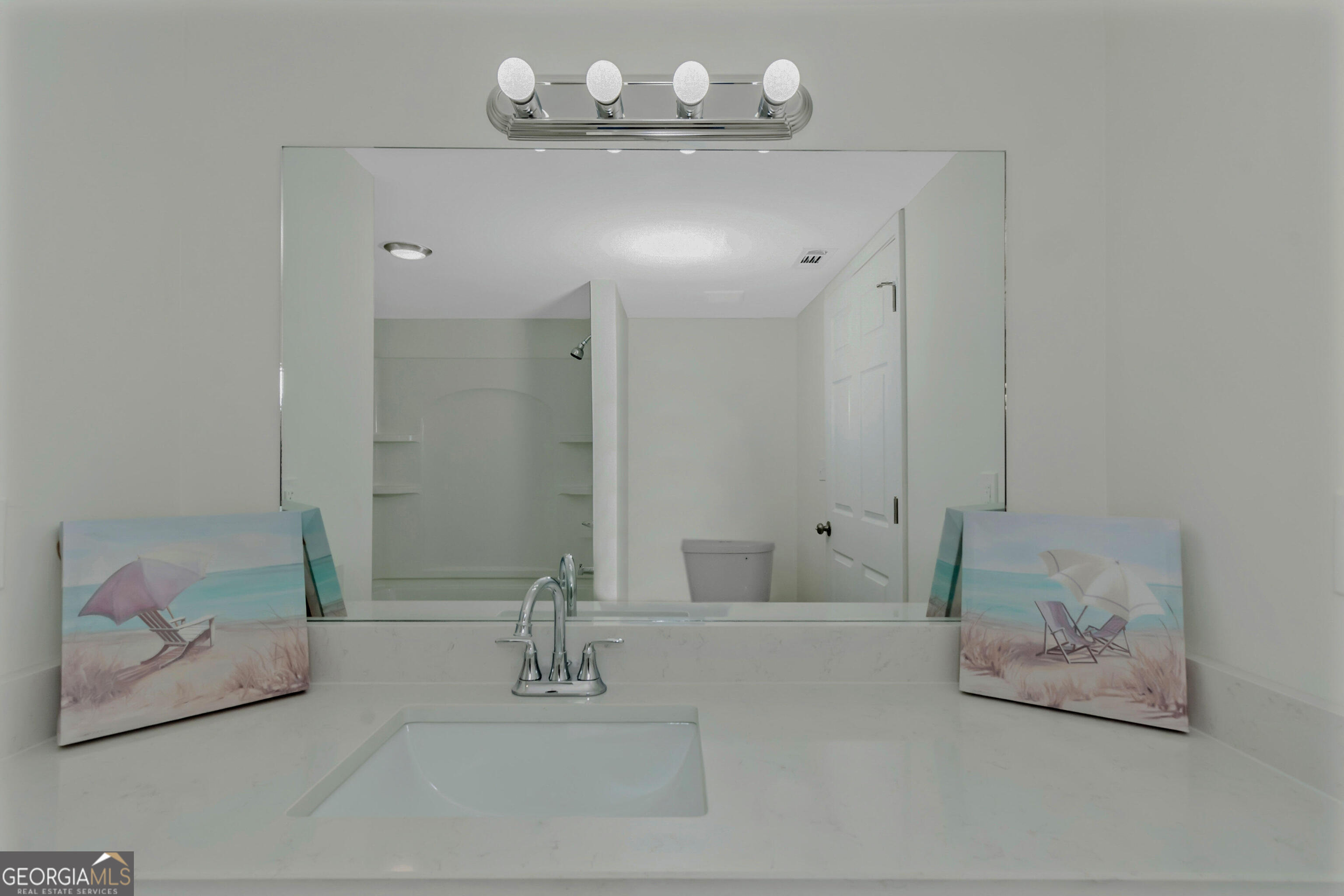 204 Mill Street Barnesville, GA 30204 - Photo 21 of 35 a bathroom with a mirror and a shower