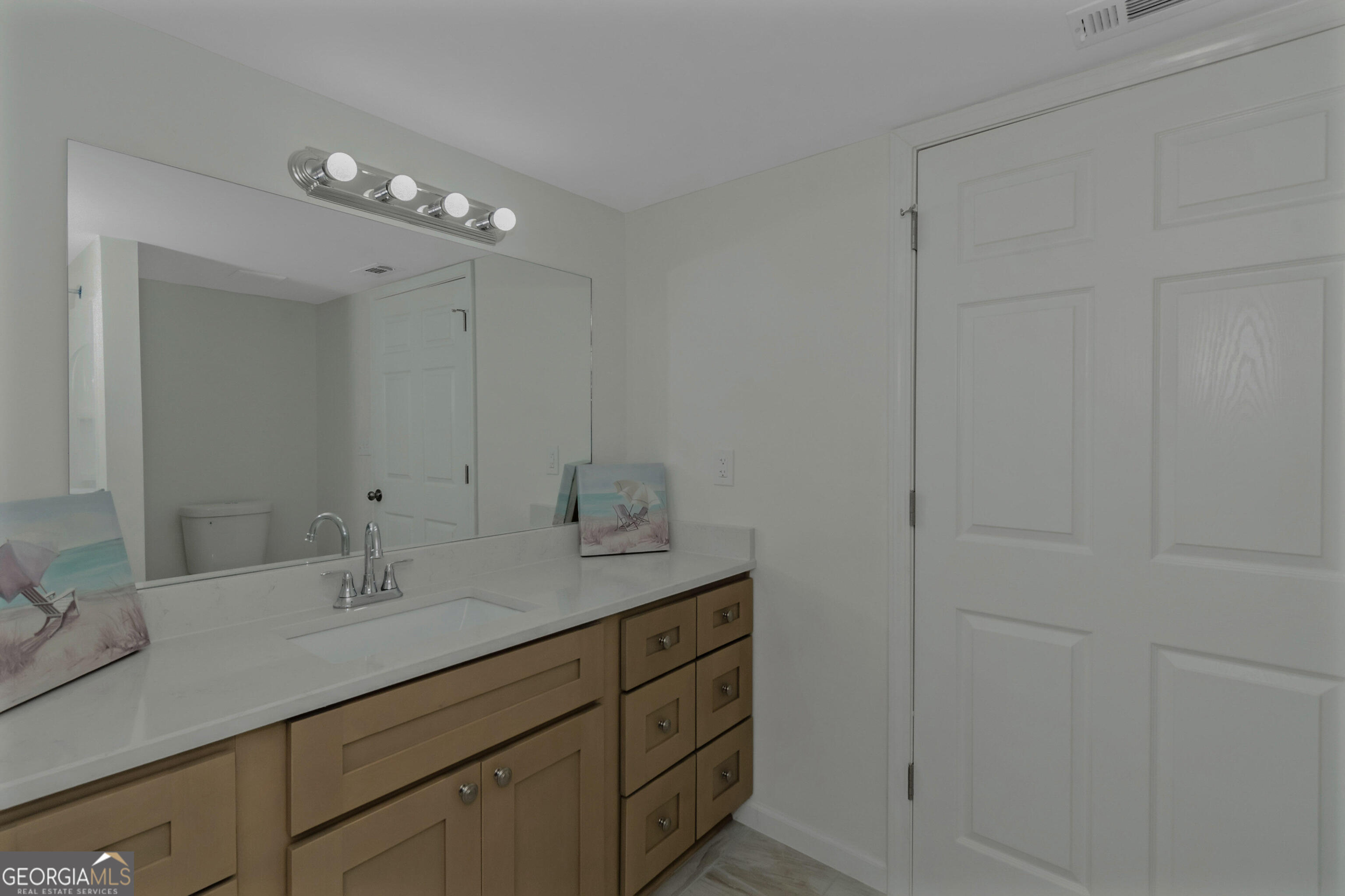 204 Mill Street Barnesville, GA 30204 - Photo 22 of 35 a bathroom with a sink vanity and mirror