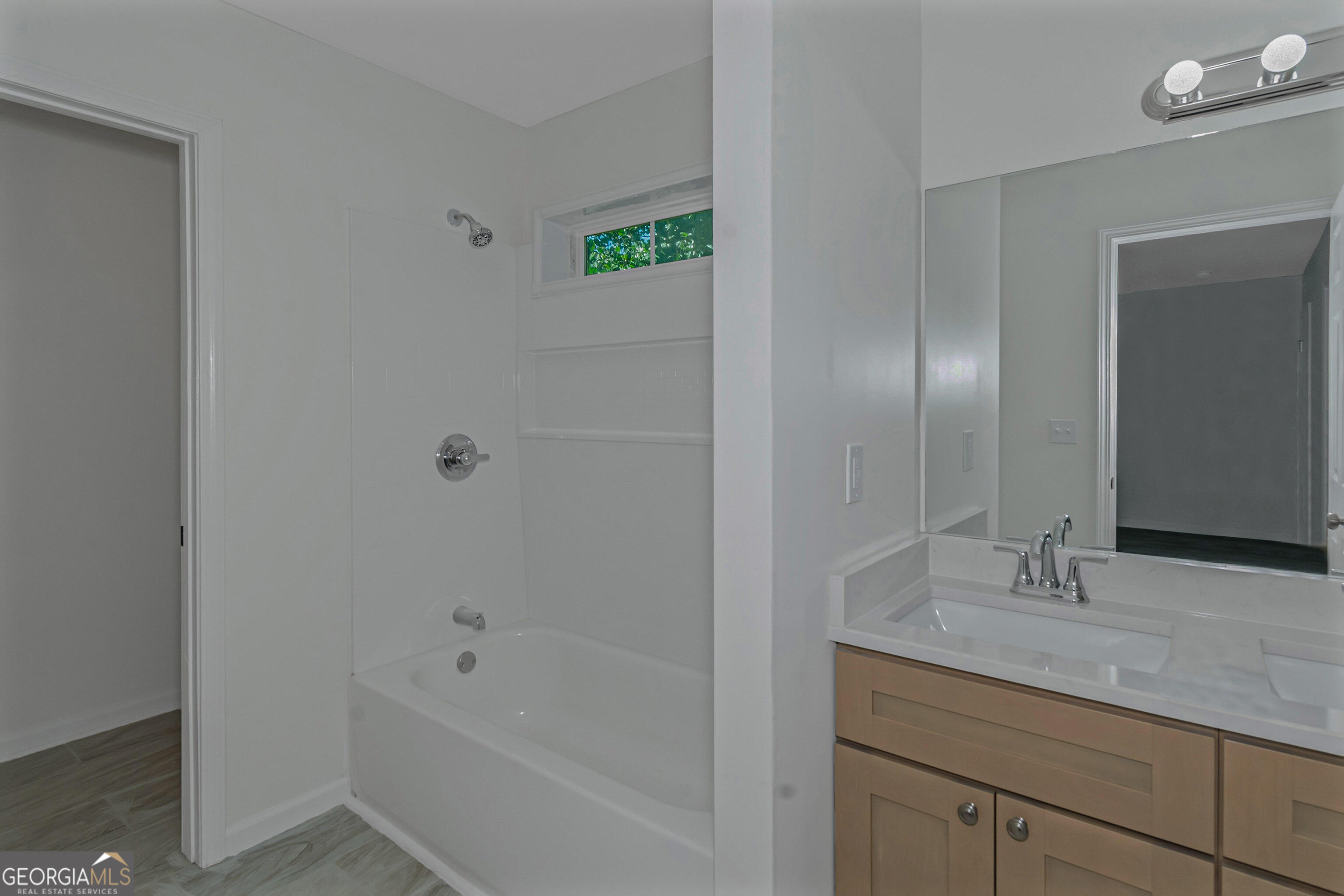 204 Mill Street Barnesville, GA 30204 - Photo 30 of 35 a bathroom with a tub shower vanity and a sink