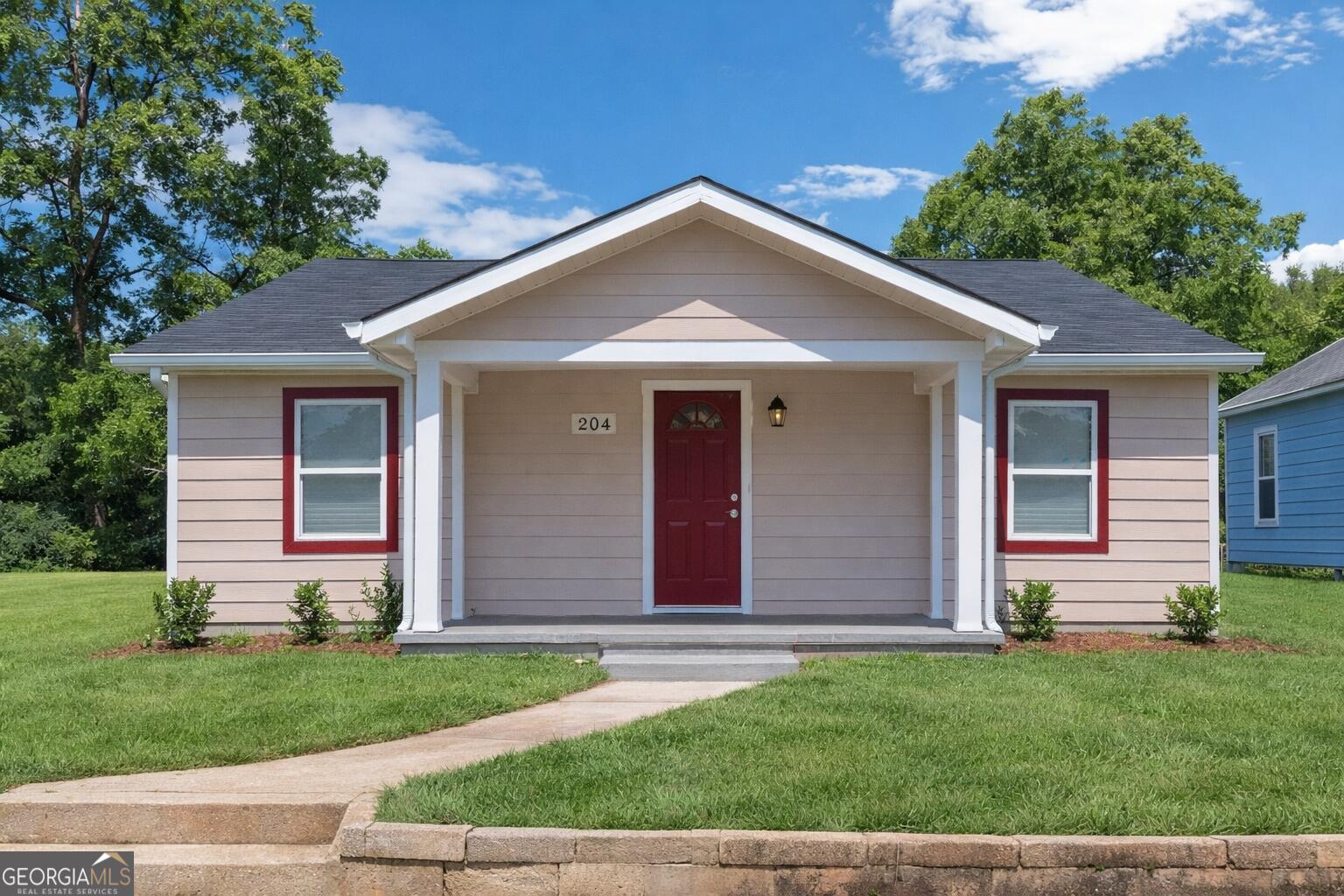 204 Mill Street Barnesville, GA 30204 - Photo 3 of 35 front view of a house and a yard