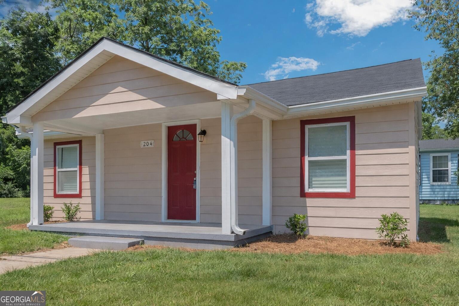 204 Mill Street Barnesville, GA 30204 - Photo 5 of 35 a front view of house with yard