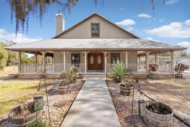 a view of a house with backyard outdoor seating area and barbeque oven
