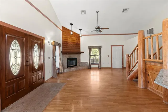 a view of staircase with lots of frames on wall and wooden floor