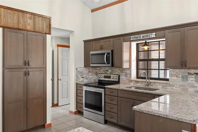 a bathroom with a granite countertop sink a toilet and a mirror