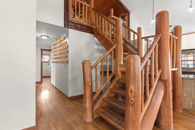 an empty room with windows and ceiling fan