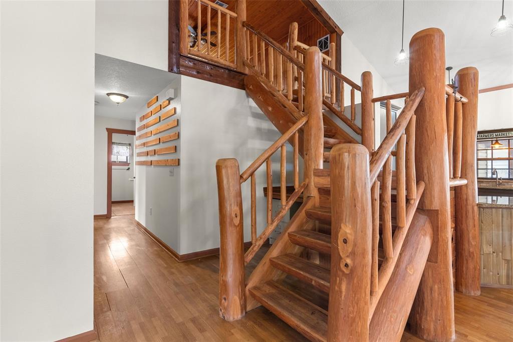 17620 North Poyner Road Polk City, FL 33868 - Photo 20 of 46 a view of staircase with lots of frames on wall and wooden floor