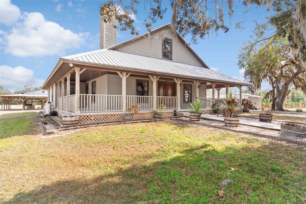 17620 North Poyner Road Polk City, FL 33868 - Photo 2 of 46 a view of a house with swimming pool and sitting area