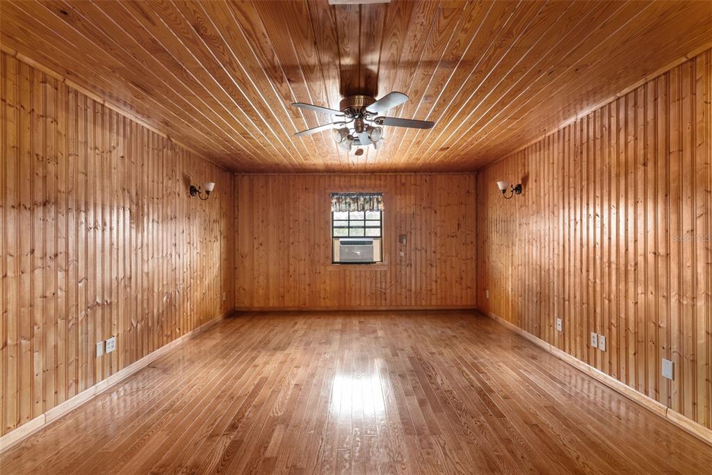17620 North Poyner Road Polk City, FL 33868 - Photo 21 of 46 a view of an empty room with wooden floor and a window