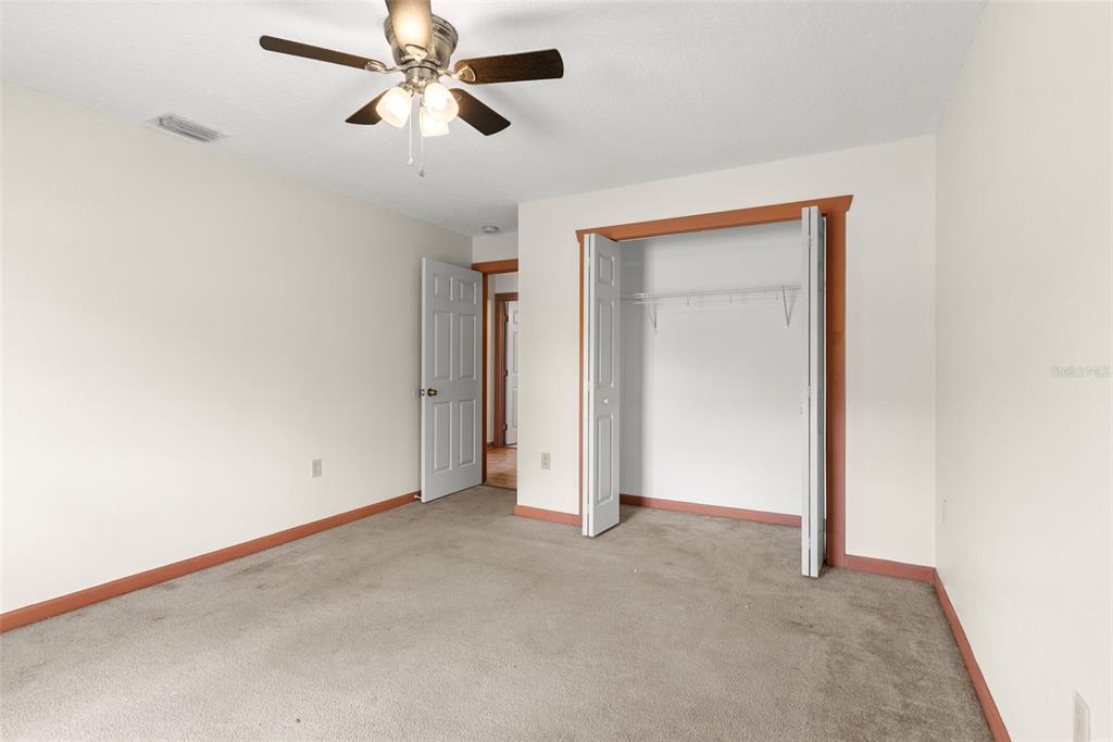 17620 North Poyner Road Polk City, FL 33868 - Photo 28 of 46 an empty room with closet and a chandelier fan