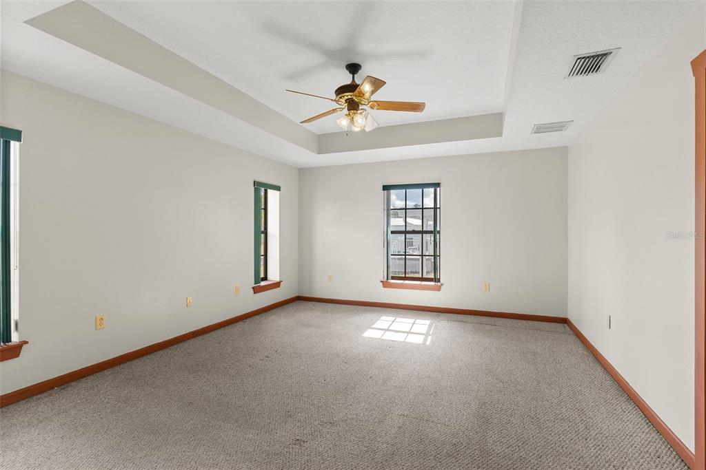 17620 North Poyner Road Polk City, FL 33868 - Photo 29 of 46 an empty room with windows and ceiling fan