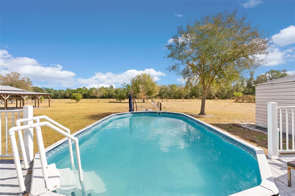 17620 North Poyner Road Polk City, FL 33868 - Photo 36 of 46 a view of a swimming pool with an ocean view
