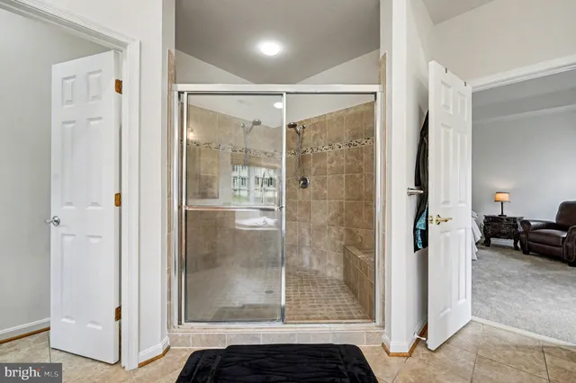 a bathroom with a glass shower door