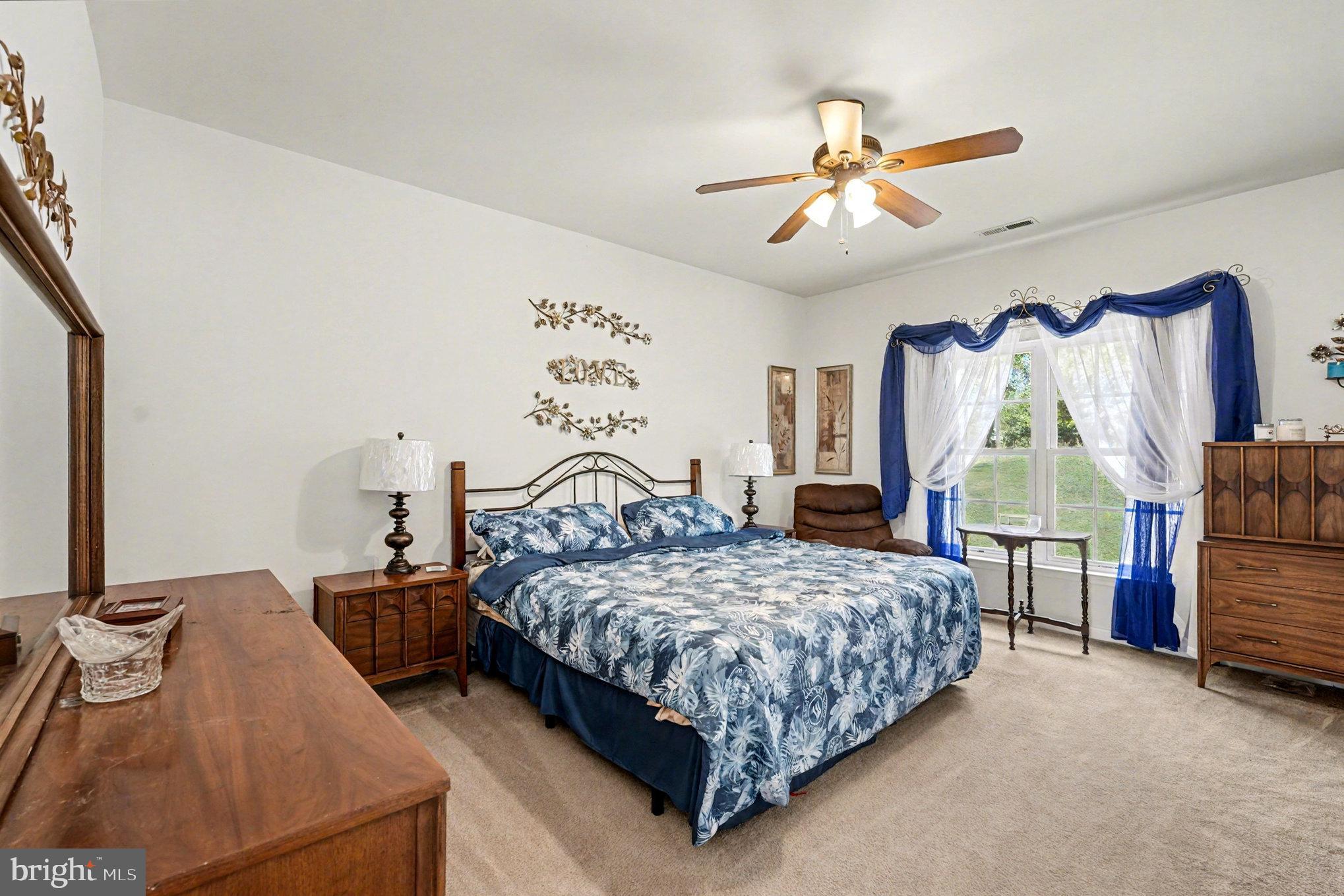 3320 McCorkle Court Triangle, VA 22172 - Photo 18 of 32 a bedroom with a bed and a chandelier