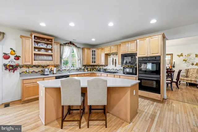 a kitchen with stainless steel appliances granite countertop a stove and a refrigerator