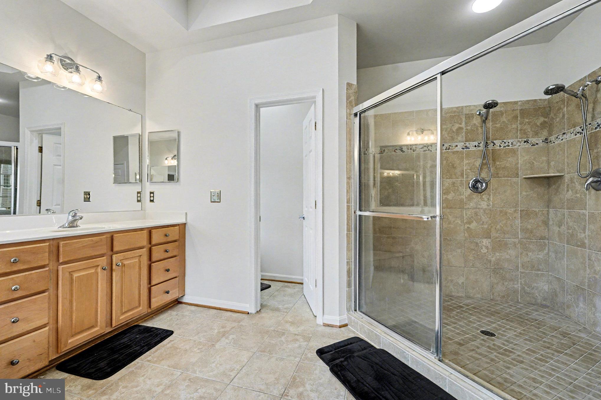 3320 McCorkle Court Triangle, VA 22172 - Photo 23 of 32 a spacious bathroom with a shower sink and mirror