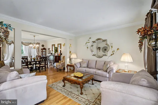 a living room with furniture and a large mirror