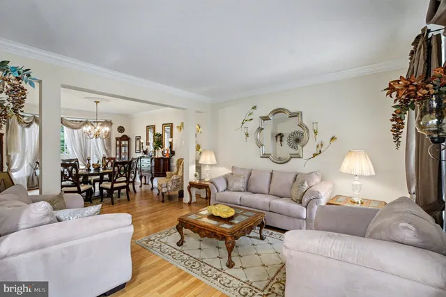 a living room with furniture and a large mirror