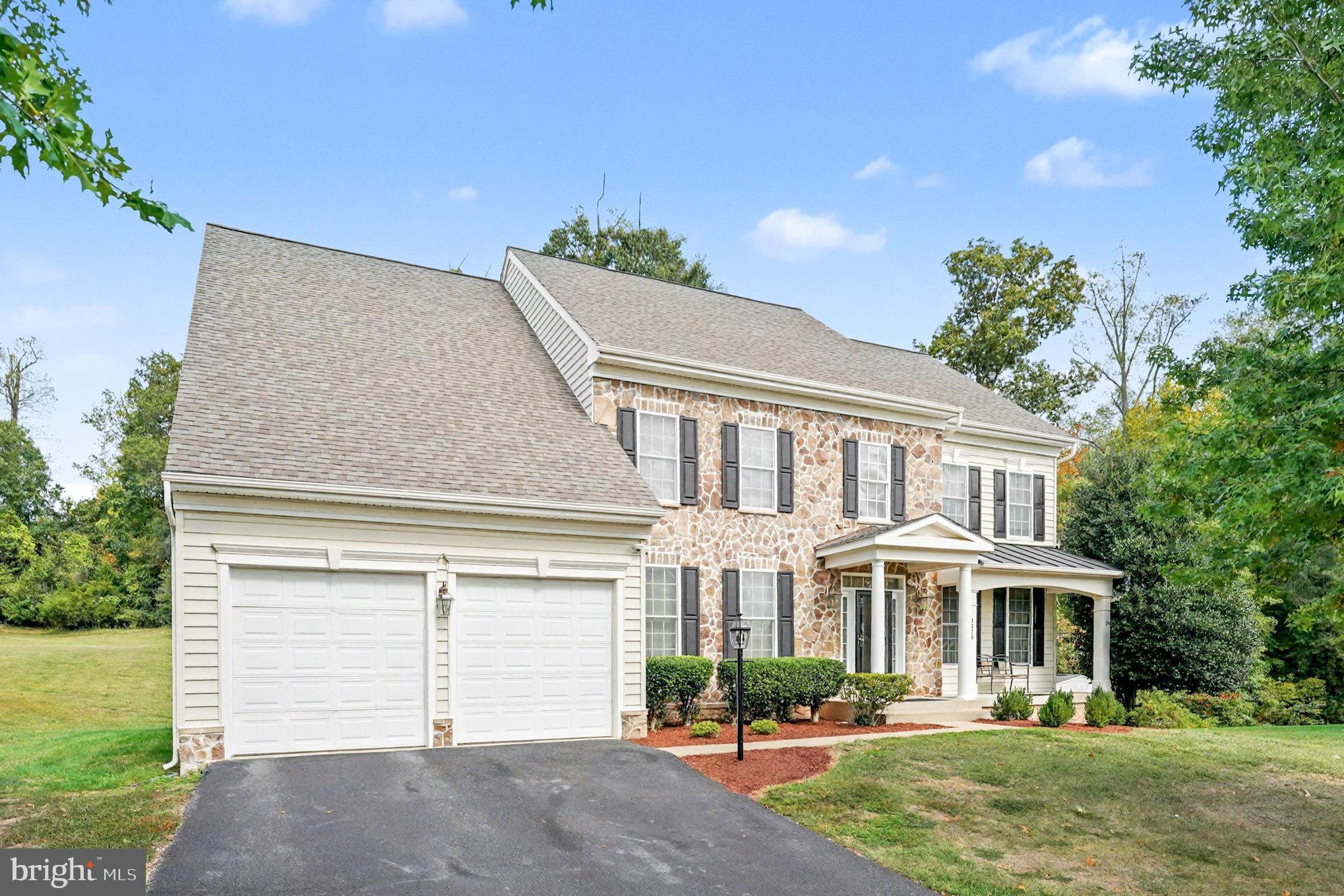 3320 McCorkle Court Triangle, VA 22172 - Photo 26 of 32 a front view of a house with a garden and plants