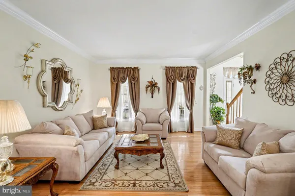 a living room with furniture or couch and a wooden floor