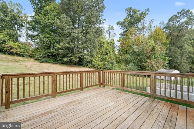 a view of deck with wooden floor and fence